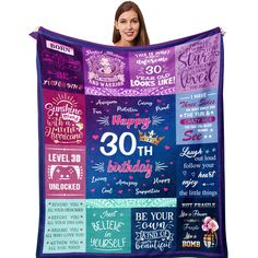 a woman holding up a birthday blanket with the words and sayings on it in different colors