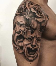 a man's arm with some tattoos on it, including two masks and roses