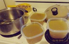 pots and pans sitting on top of a stove with food in the bottom dishes