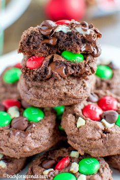 chocolate cookies with m & m candies and mints are stacked on top of each other