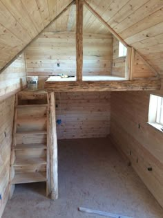 the inside of a wooden cabin with stairs