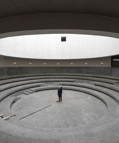 a man standing in the middle of a circular room