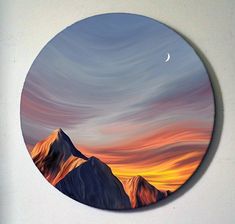 a painting on a wall with mountains in the background and a half moon above it