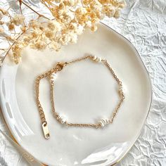 If you are interested in placing a bulk order (50+ pieces), please message us for special pricing.--Dainty 18k pearl bracelet, pearl beaded bracelet, minimalist pearl bracelet for women-- ► DETAILS  -18k gold plated over stainless steel chain + freshwater pearls -Waterproof -Length: 6 inches + 2 inches chain extender ►Heavenly Materials Our jewellery pieces are delicately handcrafted with gold-fill, sterling silver, stainless steel and gold-plating, combining rich, warm tones with an effortless Delicate Gold Chain Bracelet With Pearls, Dainty Gold Pearl Bracelet With Pearl Charm, Feminine Pearl Bracelets As Gift, Feminine Pearl Bracelet For Gifting, Dainty Gold-plated Bracelets With Pearl Charm, Dainty Gold Plated Bracelets With Pearl Charm, Dainty Gold Pearl Chain Bracelet, Delicate Rose Gold Pearl Chain Bracelet, Gold-plated Bracelet With Pearl Chain As Gift