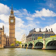 the big ben clock tower towering over the city of london, england as seen from across the river thames