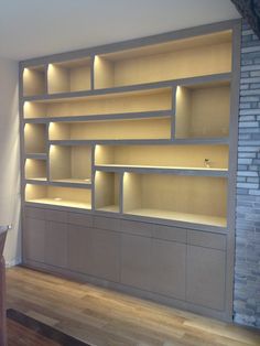 an empty room with shelves and lights on the wall