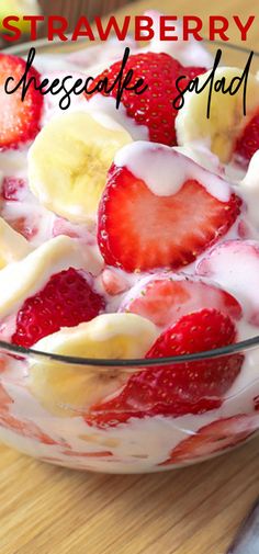 a bowl filled with strawberries and bananas on top of a wooden table next to a knife