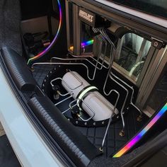 the inside of a car with two seats and a rainbow light on it's side