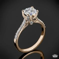 a white gold engagement ring with an oval cut diamond and side stones on the band