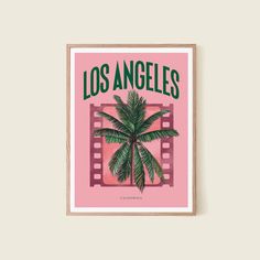 a pink poster with a palm tree on the front and los angeles written in green