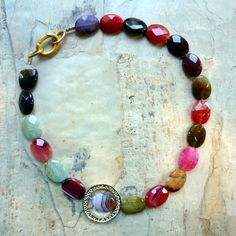 "This is a stunning statement necklace. Earth tone agate stones create a very unique piece. An 18k gold plated circle is placed on one side to give an asymmetric modern look. The colors are red, pink, brown, ocher, very light green, purple. Agate's most noticeable properties overall are balancing yin/yang energy, courage, protection, healing, and calming. Historically it was placed in water for cooking or drinking to dispel sickness. The Metaphysical and Healing Properties Lore of any specific t Summer Tones, Necklace Stones, Natural Gemstone Necklace, Nugget Necklace, Summer Necklace, Agate Necklace, Agate Stone, Earth Tones, Gemstone Necklace