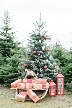 a christmas tree with presents in front of it