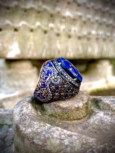 Baroque Ornate Ring Victorian Ring Pave Stones Rococo Men Ring Dark Blue Enamel Ring Gold Leaf Embroidered Lapis Lazuli Gemstones We Made a Gold-Leaf Enamel on the Original Lapis Lazuli Stone. Pencil Processing Is Carried Out On Baroque Motifs. We have Integrated the Motif Decoupage with the Original Enamel Art of Navy Blue.We Asymmetrically Nailed The Stones Of Morganite, Smoky Browns, Citrine And Tourmaline On The Back Of Our Ring And Combined With Gilding and Rhodium, We Brought Out This Mast Luxury Blue Fine Jewelry Men's Ring, Luxury Men's Lapis Lazuli Jewelry, Rococo Men, Baroque Motifs, Men Jewellery, Ornate Ring, Mens Gemstone Rings, Victorian Ring, Men Rings