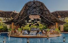 an outdoor restaurant with a pool and seating area