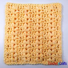 the crochet square is made up of yellow yarn