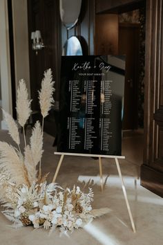 a wedding seating chart with flowers on the floor