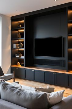 a modern living room with built - in entertainment center and large screen television on the wall