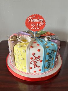 a birthday cake decorated with colorful designs on a table