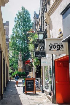 people walking down the street in front of yoga studios and shops on both sides