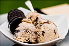 an ice cream dish with cookies and oreo cookies in it on a white plate