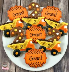 some cookies are decorated to look like construction trucks and dirt tracks with the numbers 2 - 3 on them