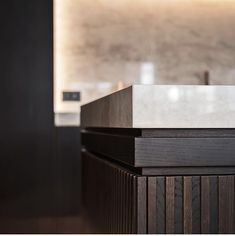 the counter top is made out of wood and has a white marble block on it