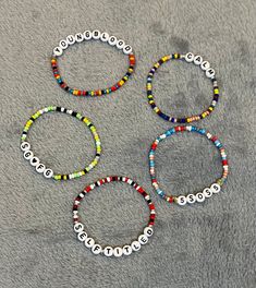 Are you going to a concert anytime soon? Wear these cute bracelets and rock the evening in style. Bracelets are made with faux glass beads in a variety of colors. Alphabet and number beads are used to spell out 5SOS' albums. Bracelets are approximately 6.75 inches in circumference. One size fits most. 5 bracelets in the bundle. Free shipping 5sos Bracelet Ideas, Party Beaded Bracelets With Letter Beads And Round Beads, Multicolor Beaded Bracelets With Letter Beads For Party, Party Multicolor Friendship Bracelets With Letter Beads, 5sos Friendship Bracelet, Multicolor Letter Beads Friendship Bracelet For Parties, Party Bracelet With Letter And Round Beads, Party Bracelets With Round Letter Beads, Multicolor Letter Beads Friendship Bracelets For Party