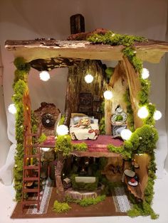 a doll house made out of wood with lights and moss growing on the outside wall