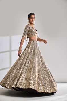 This lehenga set features all over seqin embroidery in a chevron pattern on a deep wine raw silk base. The outfit is paired with a plunging neckline and a gold tissue organza dupatta with metallic thread tassels.From Seema Gujral’s Night at the Opera collectionDELIVERY TIMEPlease wait 8-12 weeks for your outfit to arrive.FABRIC DETAILSRaw SilkProfessional cleaning only. Burnt Orange Indian Outfit, Sequin Lehenga Indian Weddings, Tissue Lehenga Designs, Orange Indian Outfit, Tissue Lehenga, Manish Malhotra Lehenga, Sequin Lehenga, Sanjeev Kumar, Seema Gujral