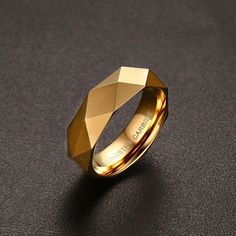 a gold ring that is on top of a black surface with the words, buy from gems