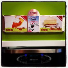 two boxes of frozen desserts are hanging on the wall above an electric stove top