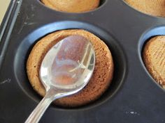 a muffin tin with some cupcakes in it and a spoon sticking out