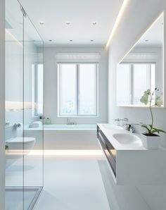 a large white bathroom with two sinks and a bathtub in the middle of it