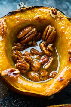 the inside of a pumpkin with nuts in it