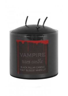 a black candle with red drips on the top and an inscription that reads vampire tears come