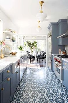 a kitchen with blue cabinets and white counter tops is featured in the instagram page