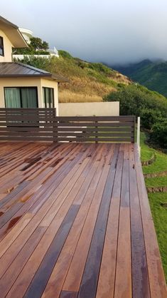 a wooden deck in front of a house