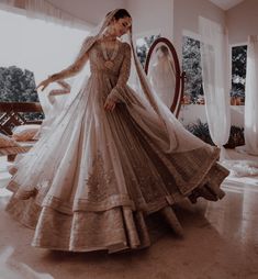 a woman in a wedding dress is posing for the camera