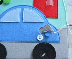 a close up of a car made out of felt with buttons on the front and back