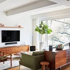 a living room filled with furniture and a flat screen tv on top of a wall