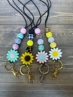 several key chains with flowers and beads on them