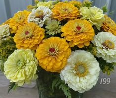 a vase filled with yellow and white flowers