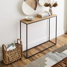 two circular mirrors on the wall above a console table