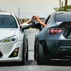 two cars parked next to each other on the street