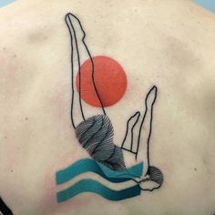 a man with a tattoo on his back holding a frisbee in the air