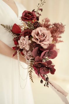 a bride holding a bouquet of flowers in her hands