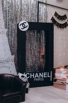 there is a chanel sign in front of the eiffel tower and other decorations