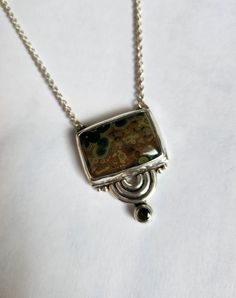 One of a kind sterling silver asymmetric geometric semicircle statement pendant.  Bezel set with a rectangular brown and green colored hasper cabochon and a faceted 4mm green tourmaline. A 16 inch chain is attached. Designed and handcrafted by Richelle Leigh using the lost wax casting process. Free shipping US. https://richellejewelry.etsy.com Harrisburg Pa, Dope Jewelry, Casting Jewelry, Funky Jewelry, Cabochon Pendant, Hippie Jewelry, Statement Pendant, Lost Wax, Jewelry Inspo