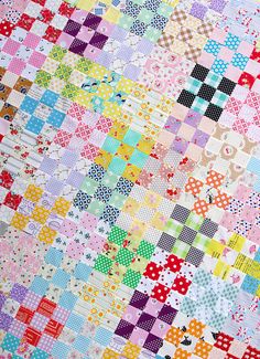 a multicolored patchwork quilt is displayed