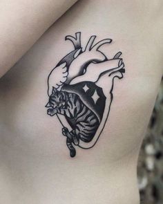 a black and white heart tattoo on the side of a woman's stomach with a tiger